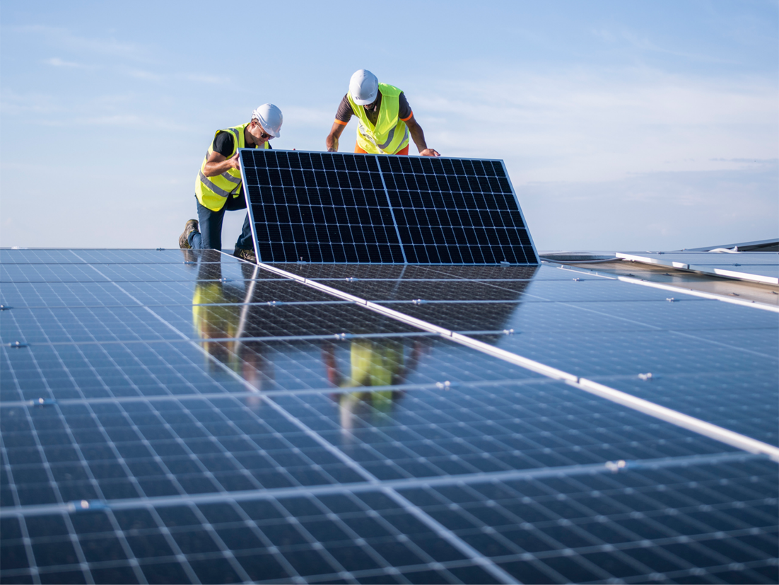 Top view of solar cell panels on a green field