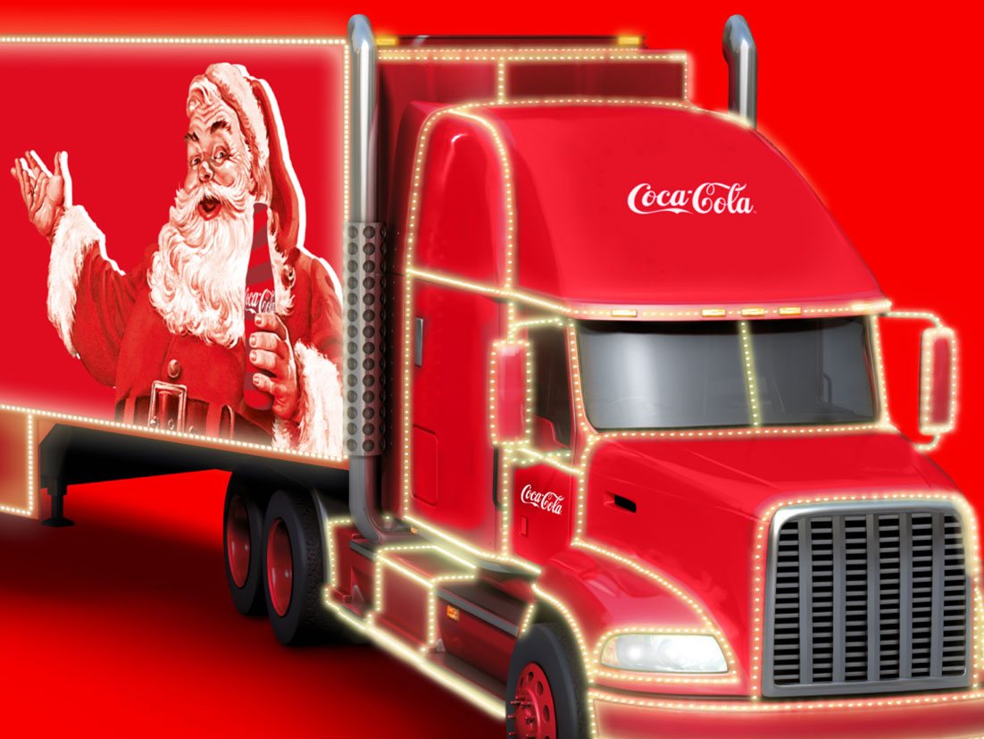 Bandeira com fundo vermelho. Há um caminhão da Coca-Cola com uma foto do Papai Noel