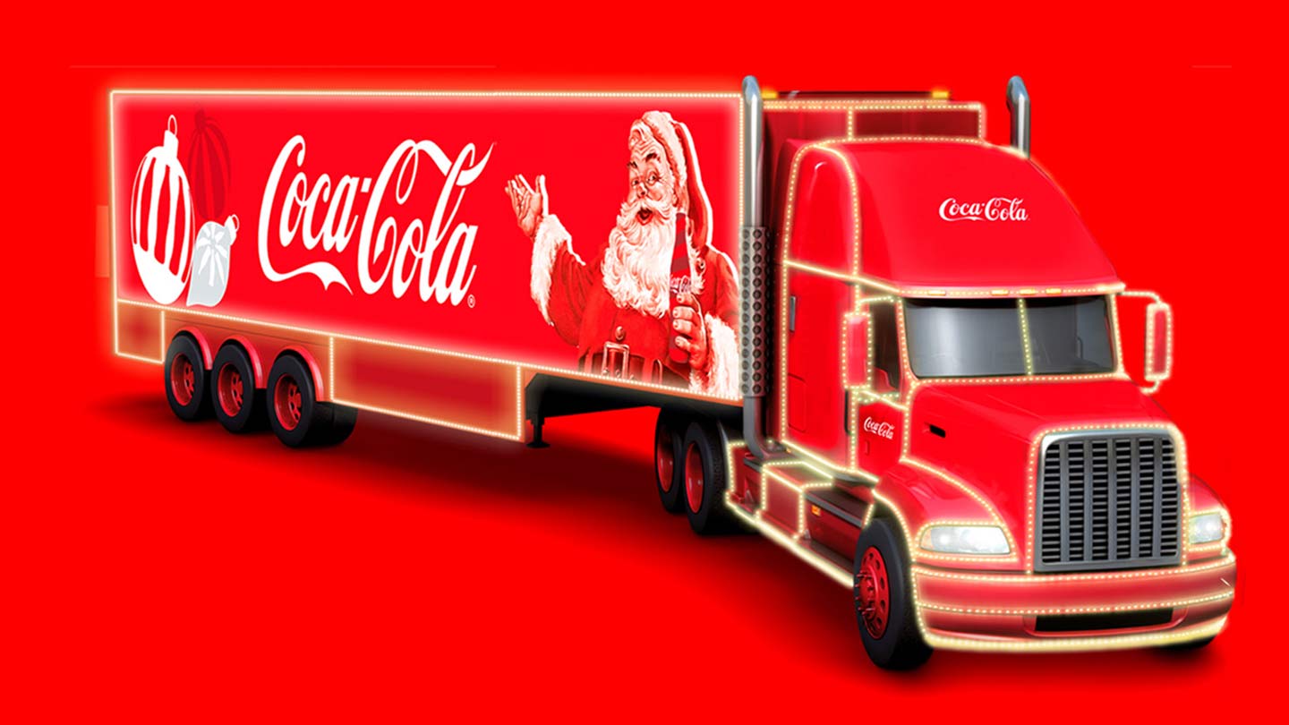 Banner com fundo vermelho. Tem um caminhão da Coca-Cola com uma foto do Papai Noel e enfeites de Natal.