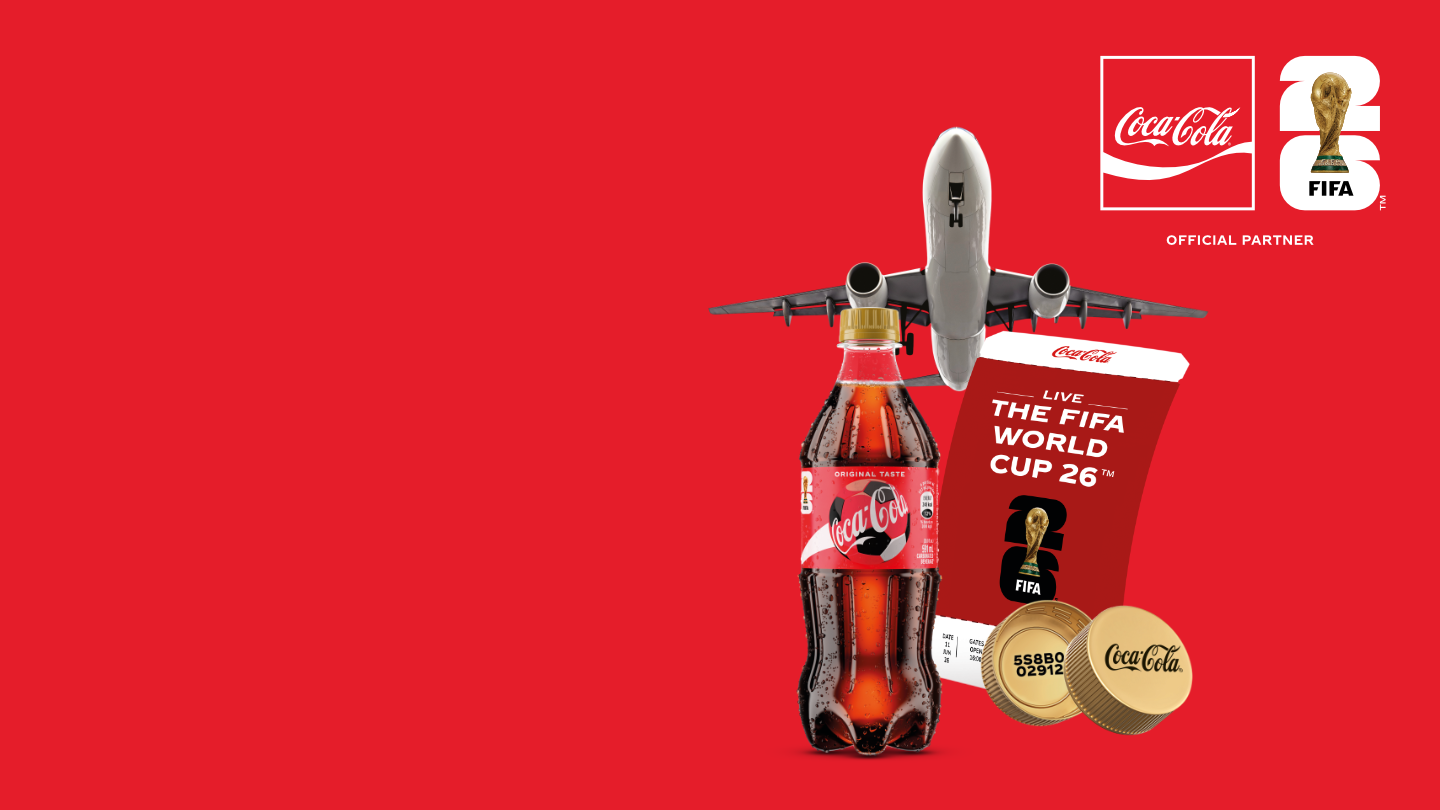 A vibrant Coca-Cola advertisement set against a deep red background, promoting the chance to win double trips to the FIFA World Cup 26™.