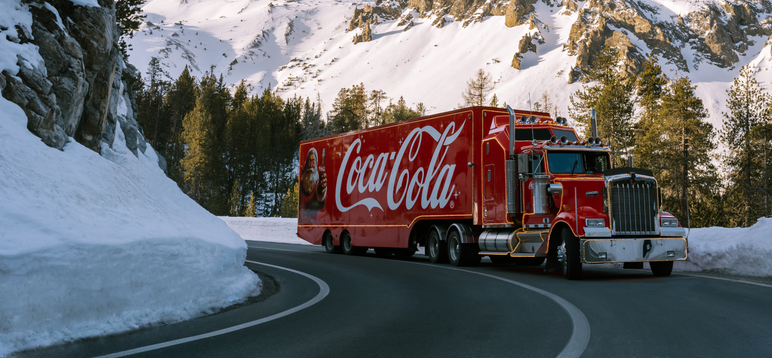 truck on a street between mountains