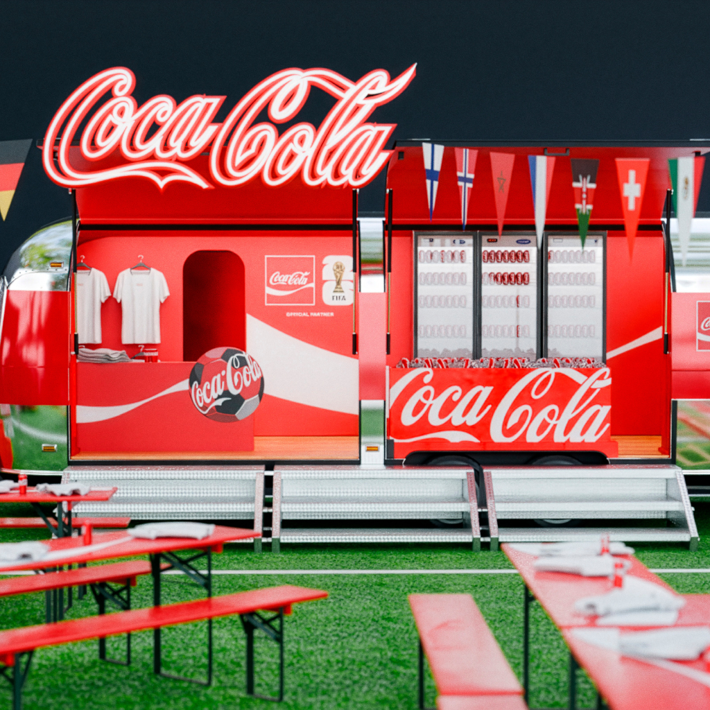 Rød Coca-Cola eventbod indrettet som fanområde med siddepladser, bannere med nationalflag og Coca-Cola-logoer, sat op på græs i fodboldstemning.