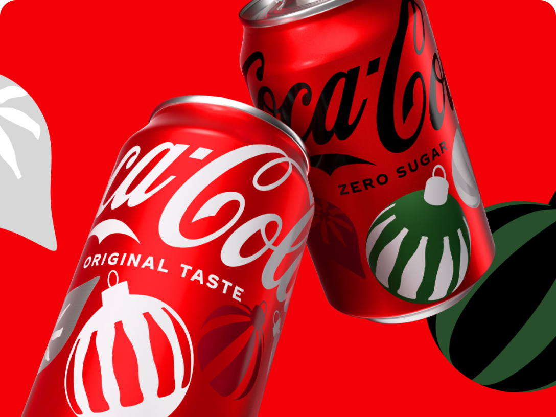 Two festive Coca-Cola cans