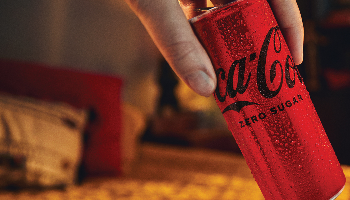 Detail of a hand holding a Coca-Cola Zero Sugar can