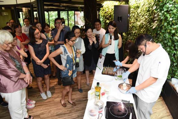 Group of people watching a chef cook