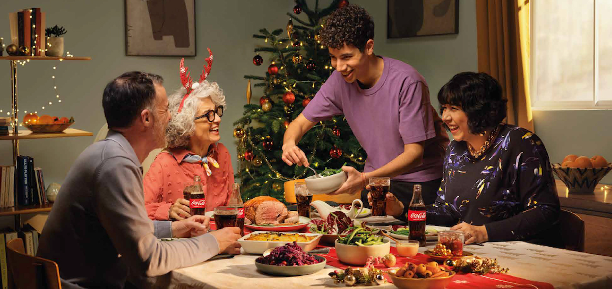 A family enjoying a holiday meal with original coca-cola