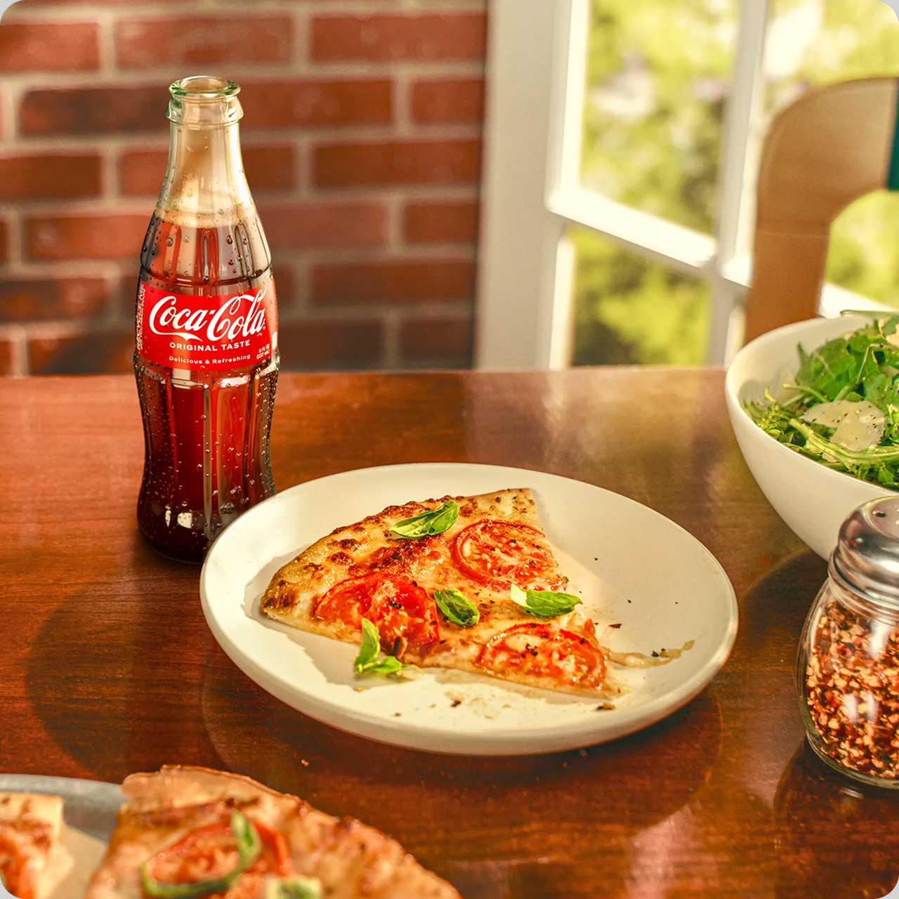 coca-cola with a plate of pizza