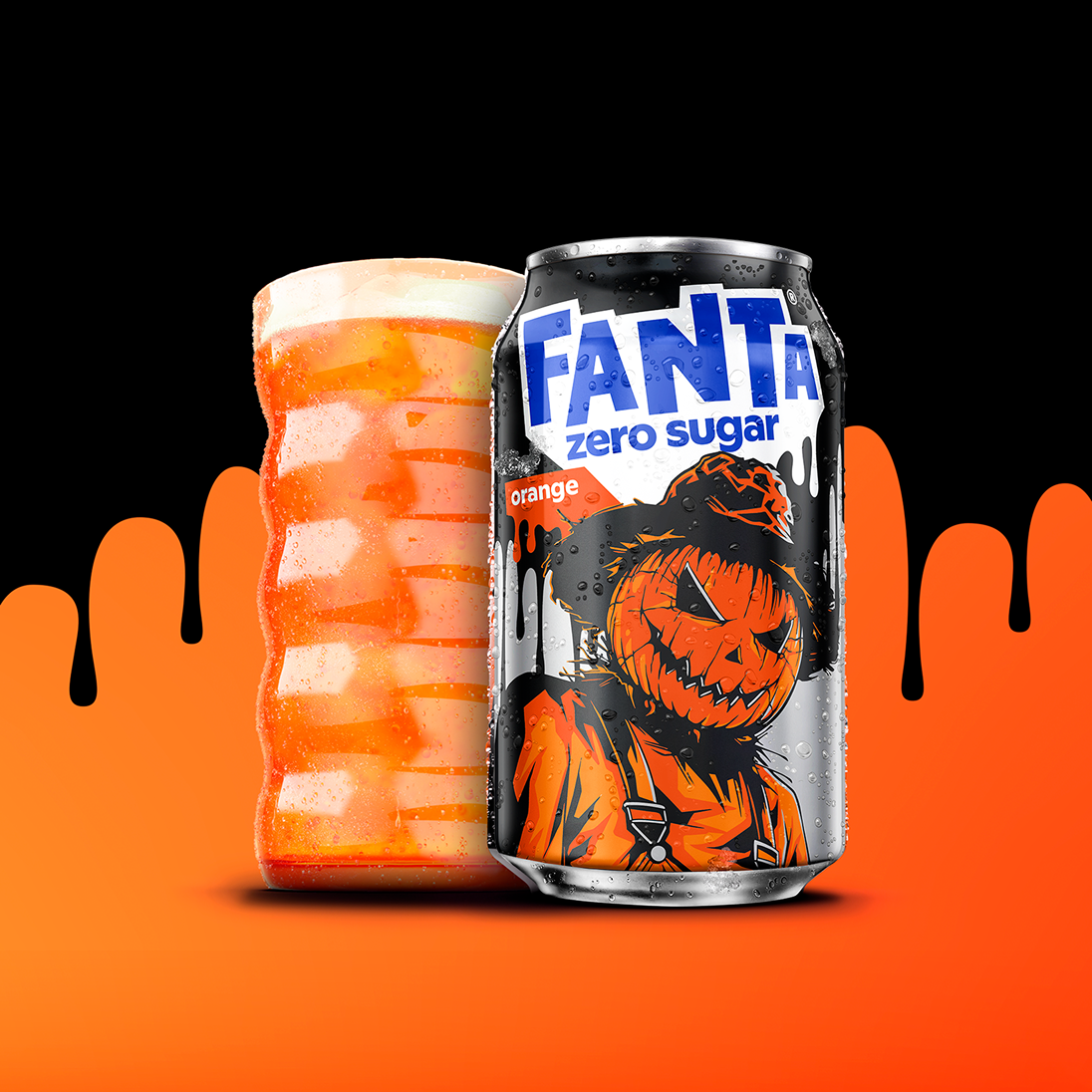 Fanta Zero Sugar Orange Halloween can with a pumpkin scarecrow, shown next to a glass of orange soda.