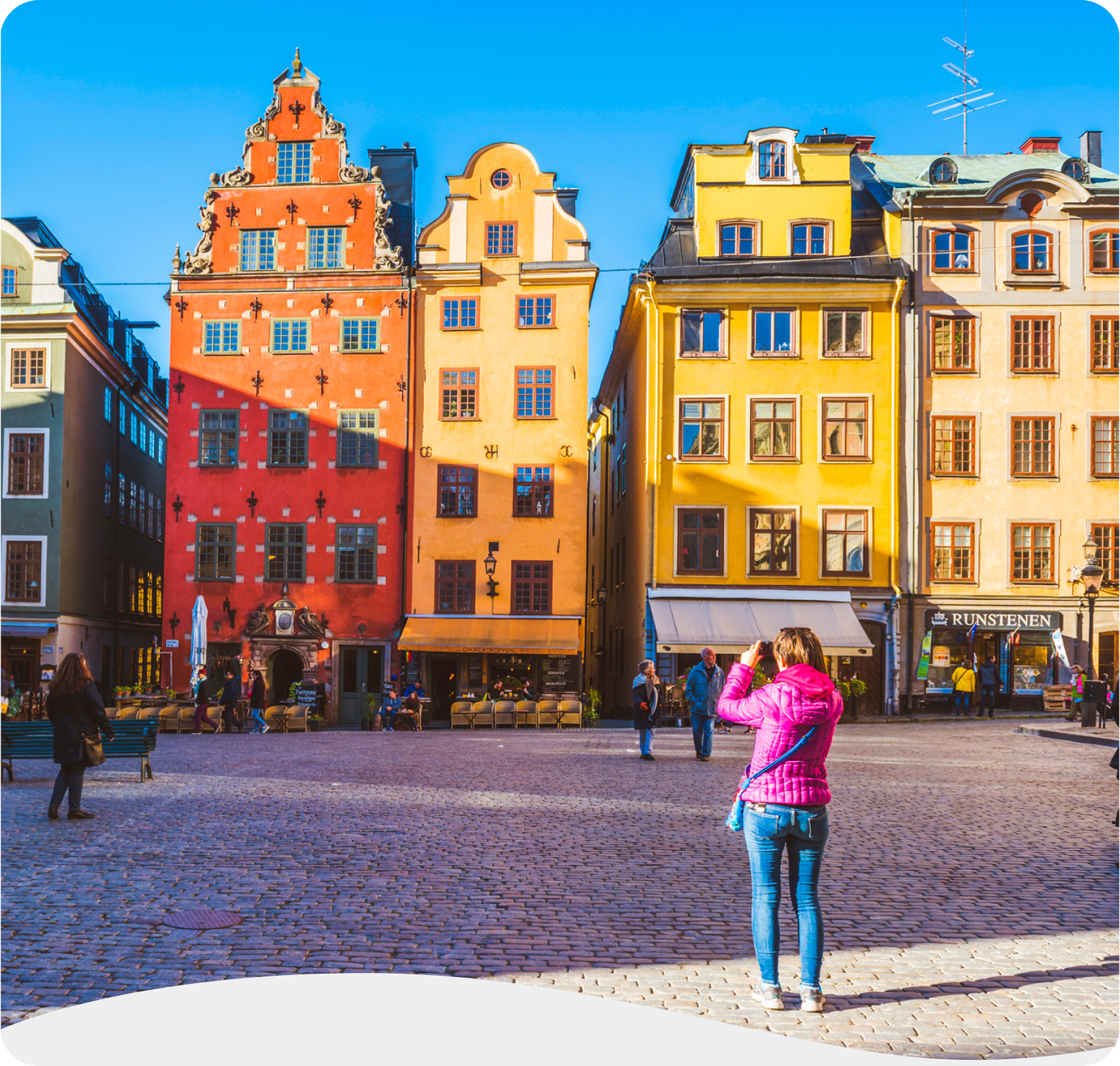 Person photographing the colorful, historic buildings in Stockholm’s iconic Old Town