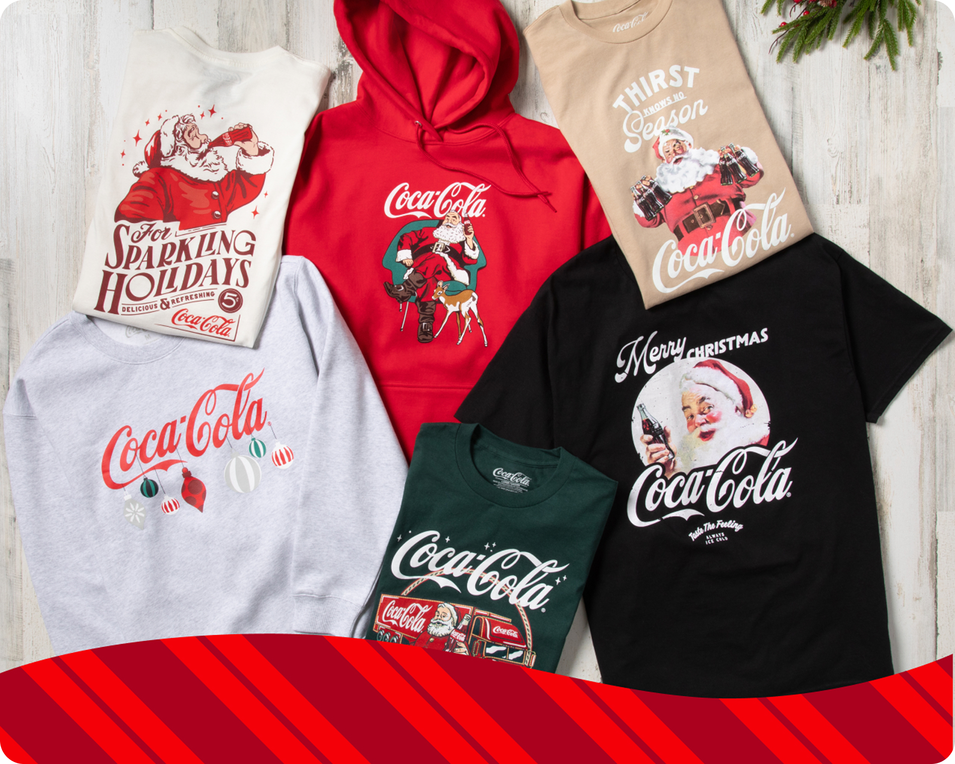 Coca-Cola branded T-shirts and sweatshirts featuring Santa imagery