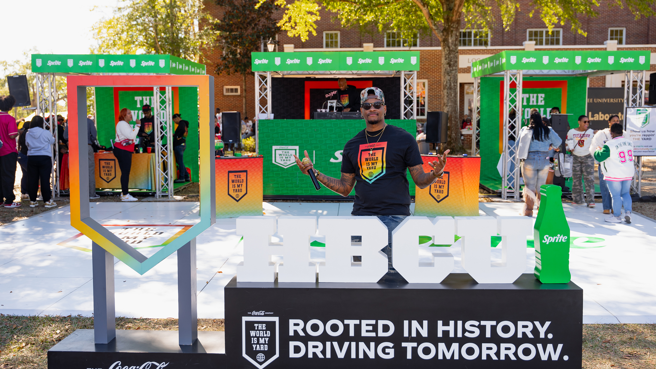 HBCU student posing in front of The World is My Yard Sprite homecoming activation on campus