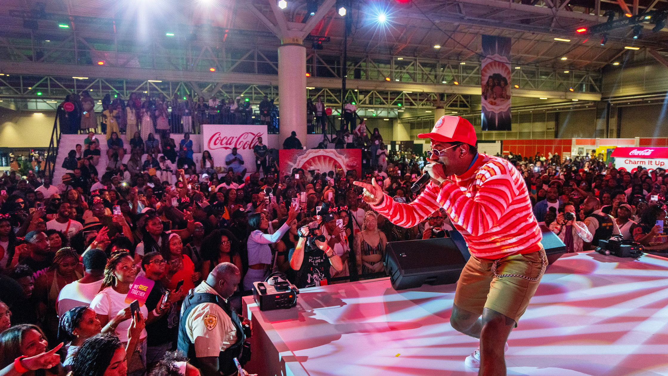 Large crowd enjoying a musical performance sponsored by Coca-Cola at ESSENCE Festival