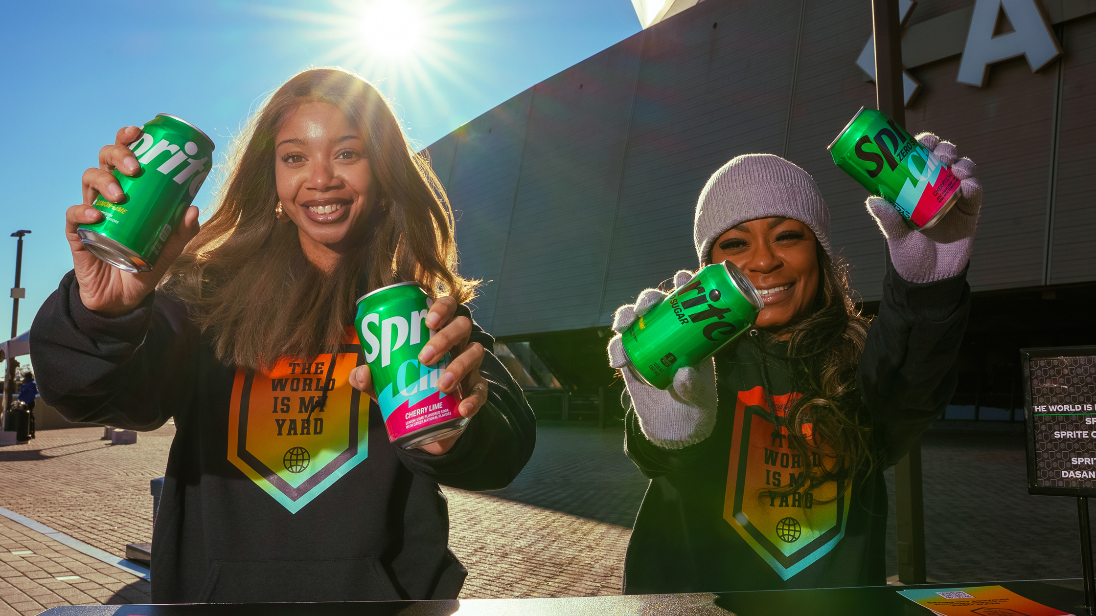 HBCU students smiling and holding a Sprite bottle at a The World Is My Yard campus activation