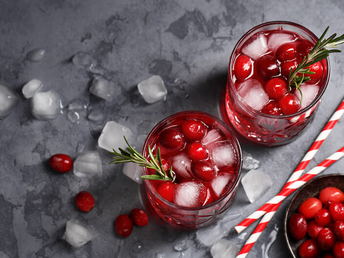 two red drinks with cranberries