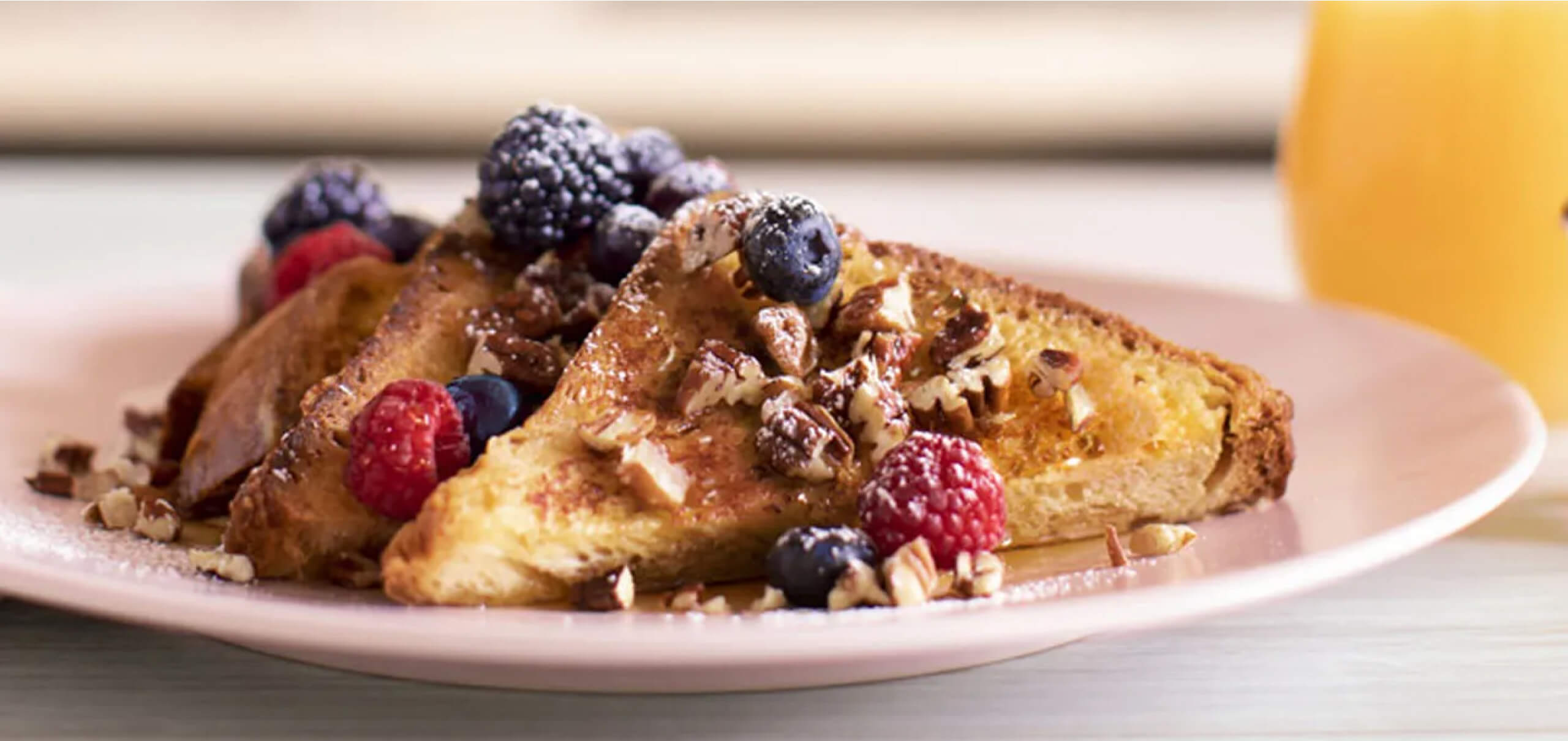 slices of french toast with berries and walnuts